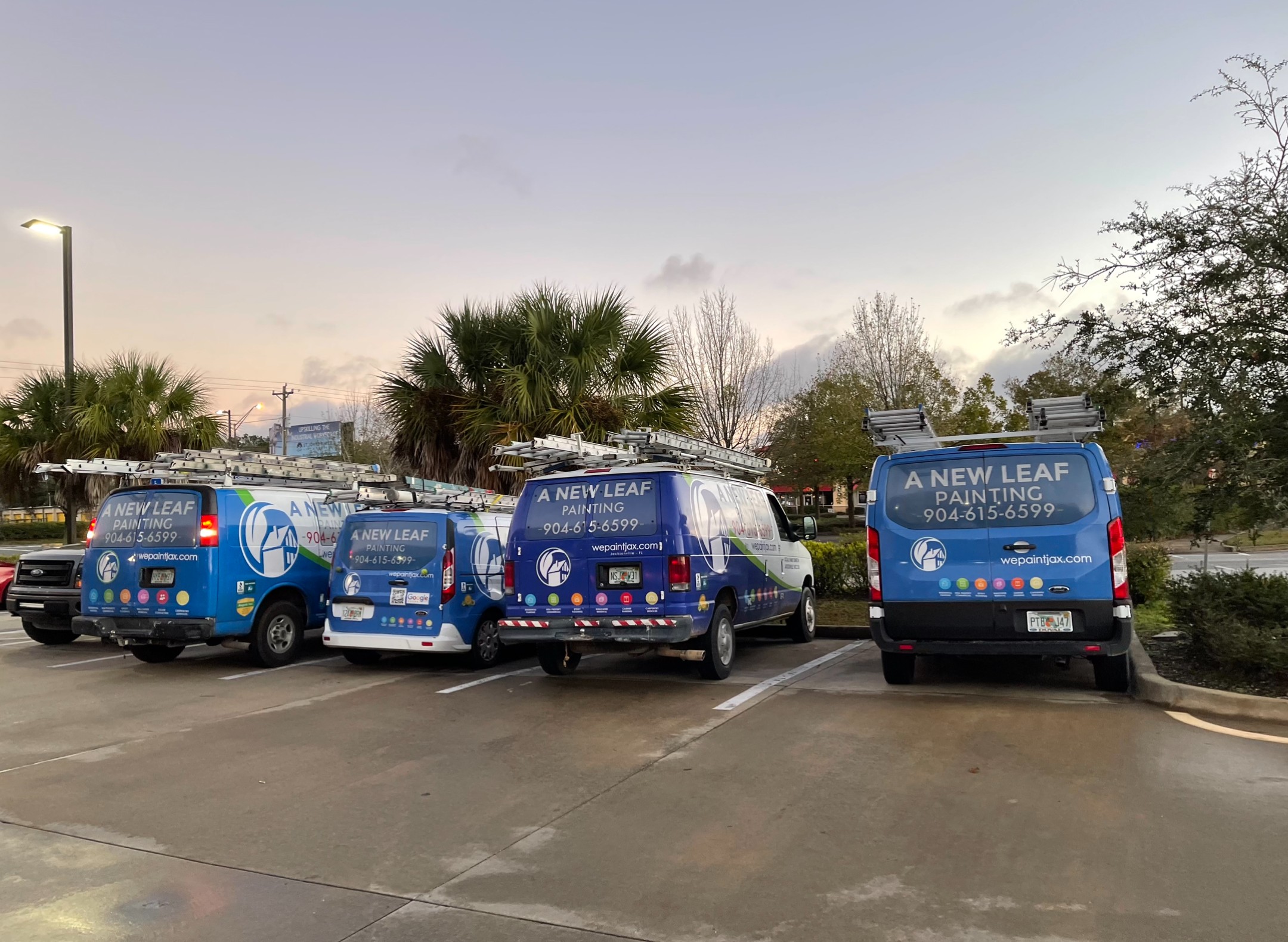 The A New Leaf Painting vans parked together