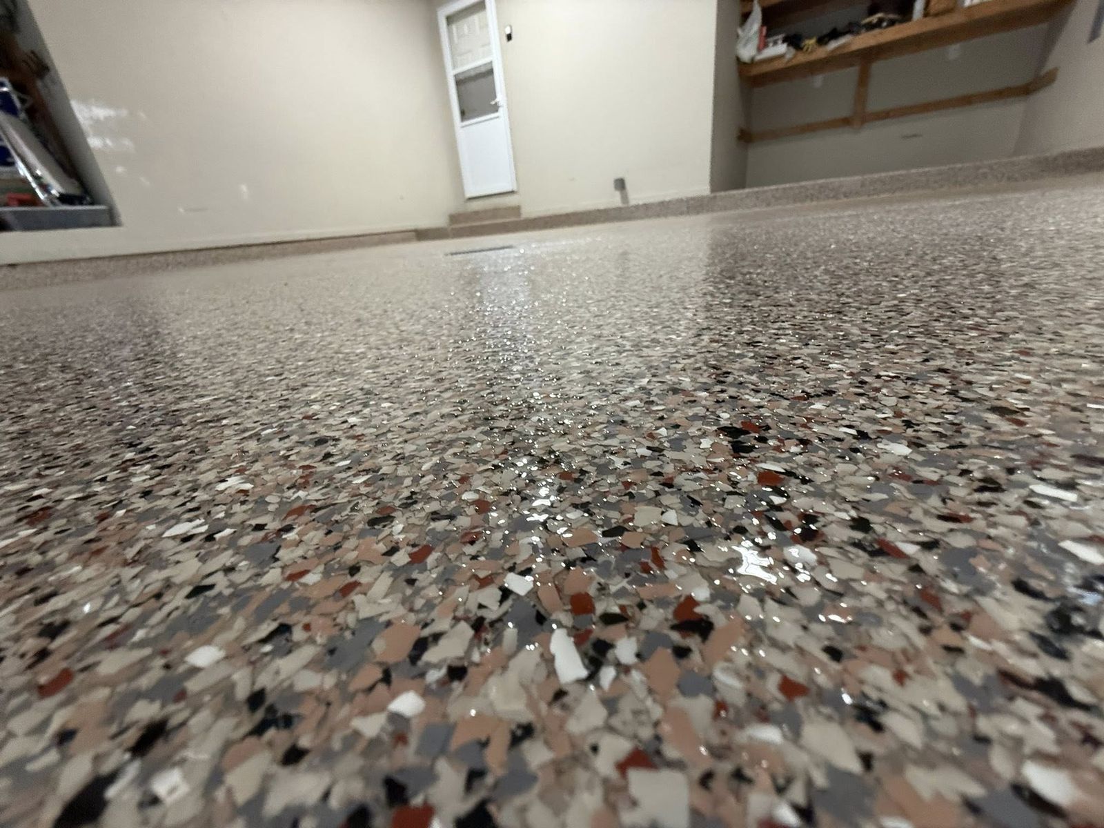 Close-up of a glossy multi-colour flake garage floor finish