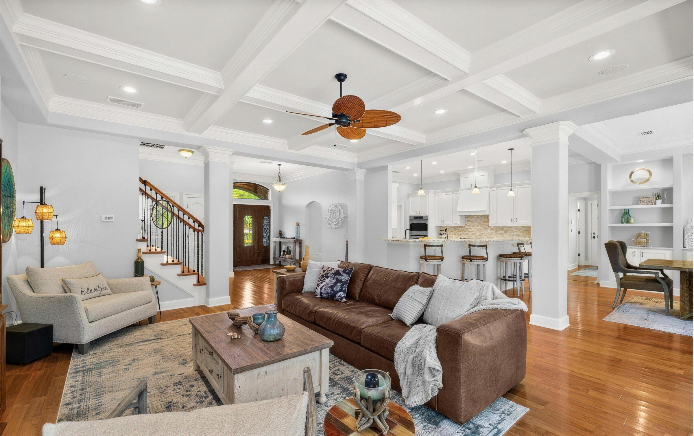 Open living room in a Jacksonville home after interior painting, a white coffered ceiling, columns and trim