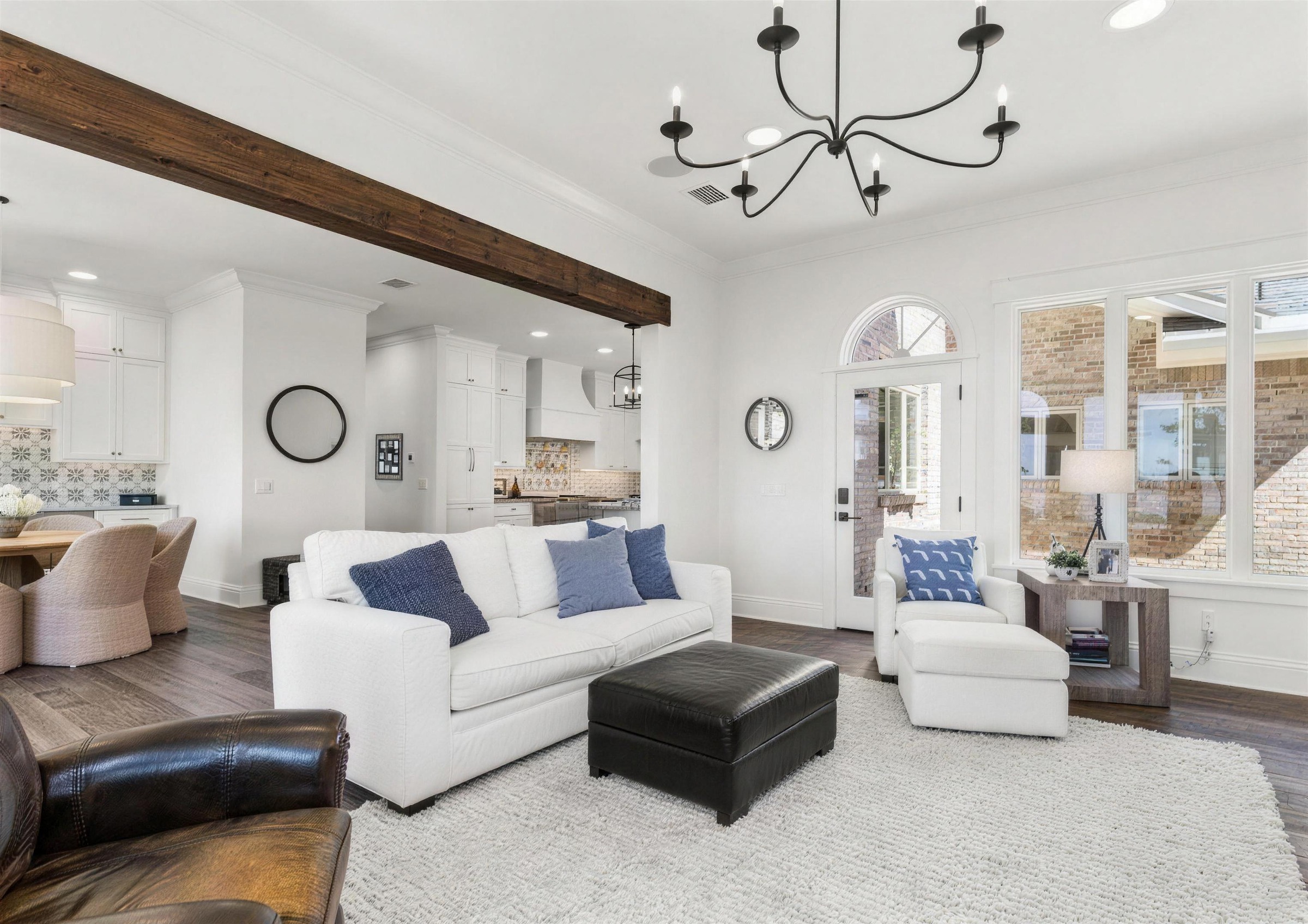 Great room in a Mandarin, Jacksonville home after interior painting, white walls, wood beams and an open kitchen