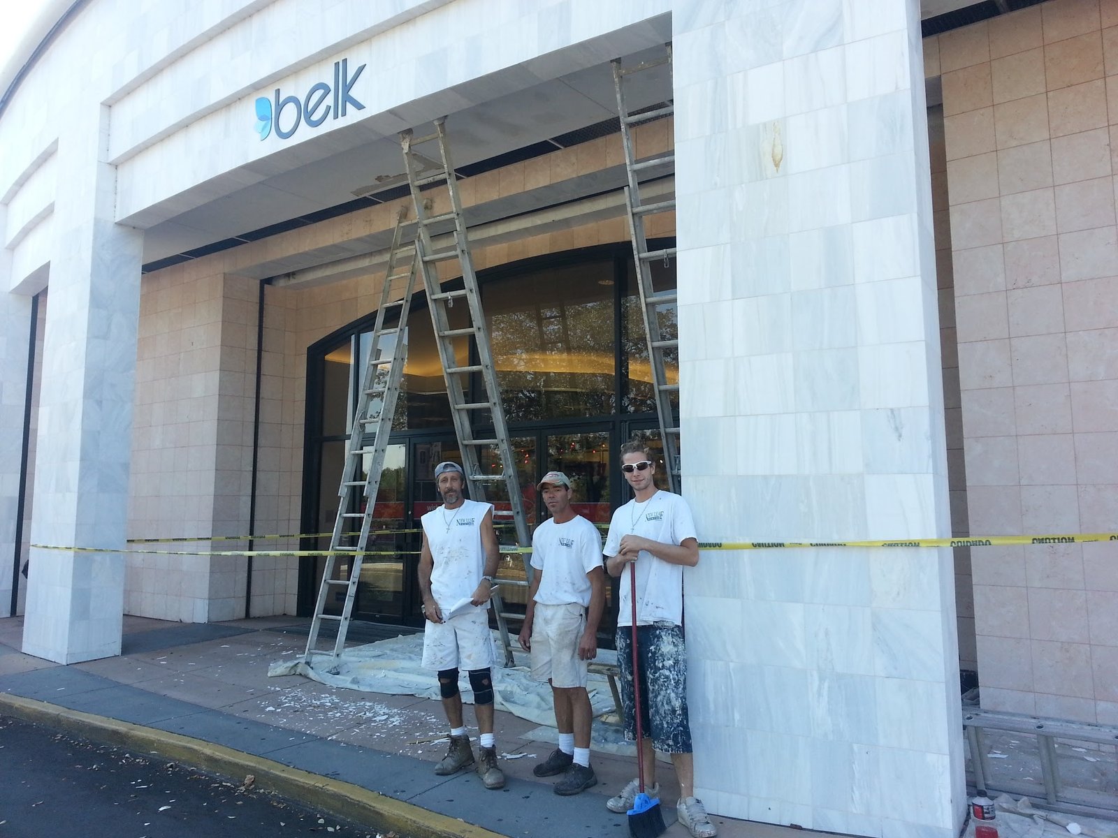 A New Leaf Painting crew at a Belk store entrance during commercial painting