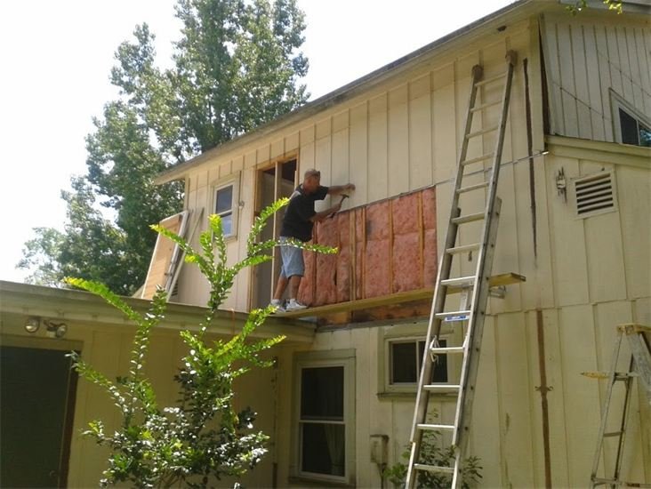 Painter replacing siding from a ladder, Jacksonville FL