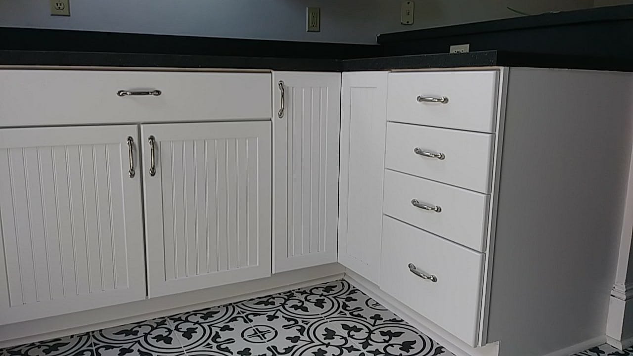 White painted beadboard kitchen cabinets and drawers