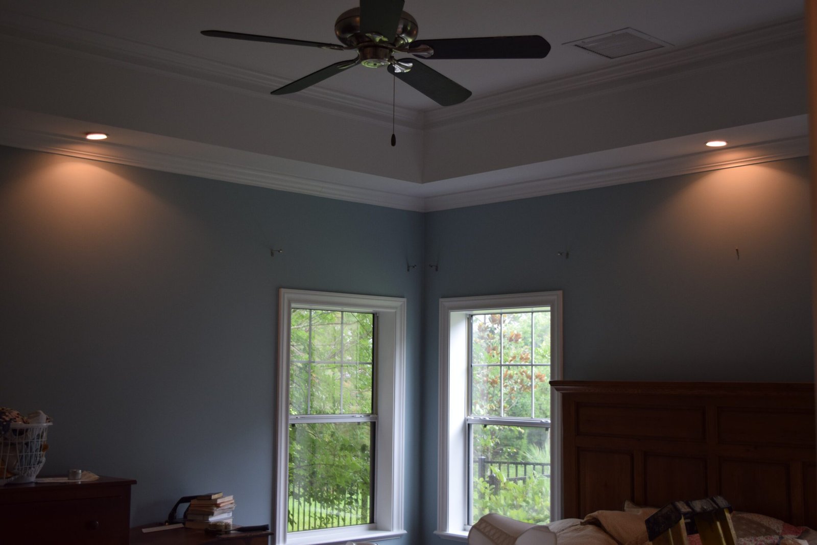 Bedroom with a smooth painted tray ceiling and crown moulding