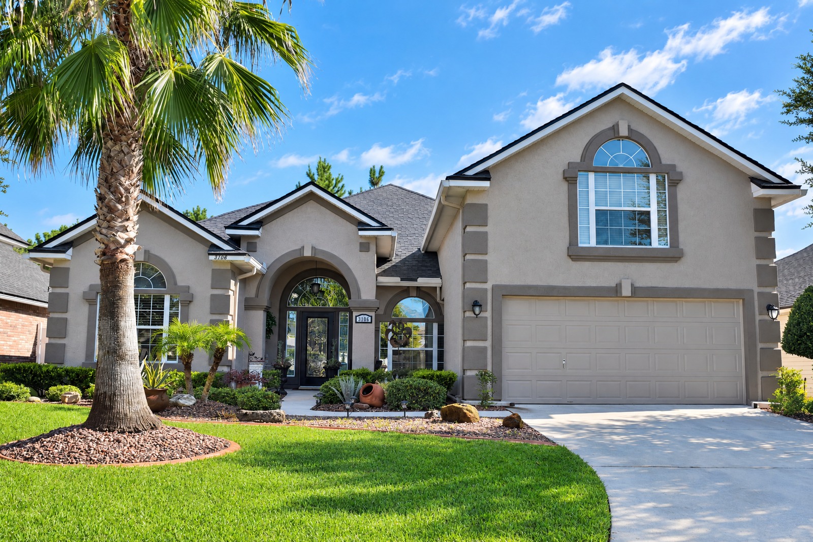 Tan stucco exterior repaint on an OakLeaf Plantation home, Jacksonville FL