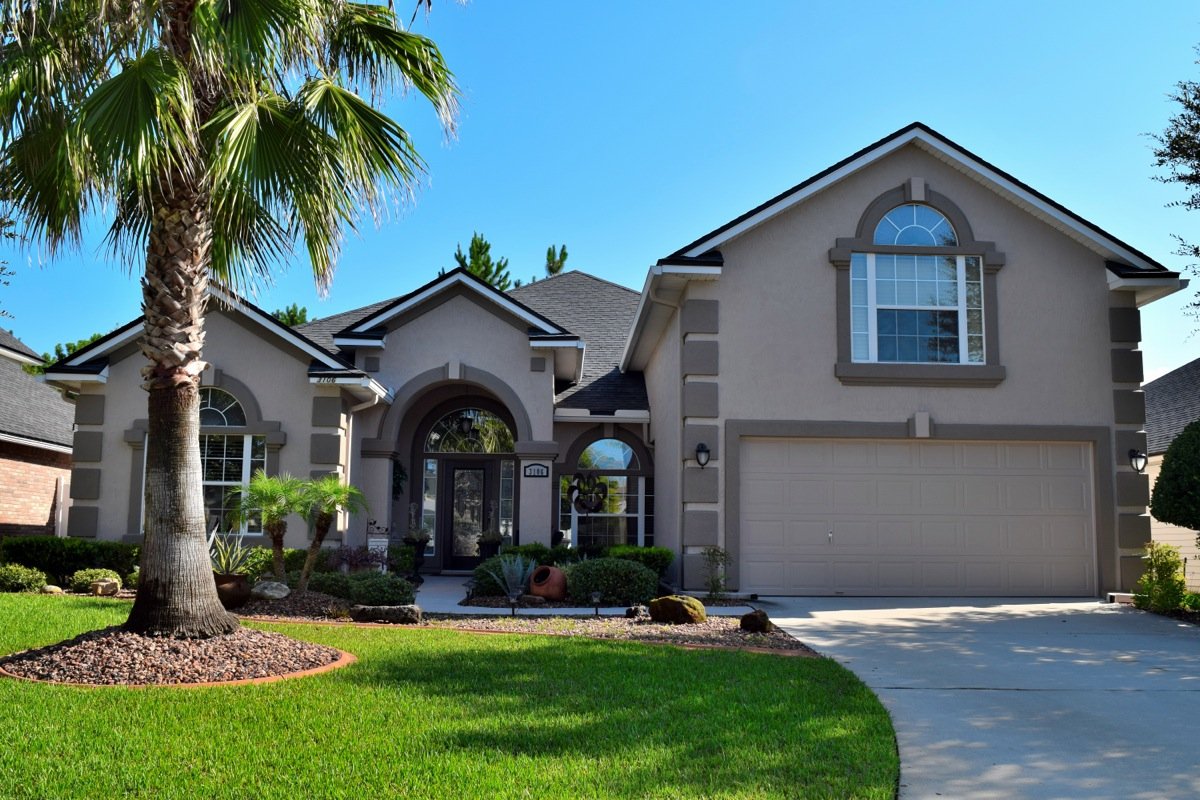 Tan stucco exterior with palm after repaint