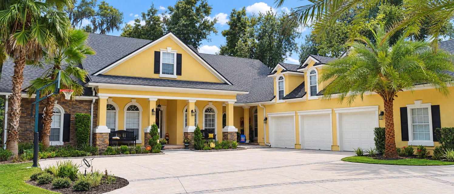 Yellow exterior with three-car garage after repaint in Ponte Vedra Beach, FL